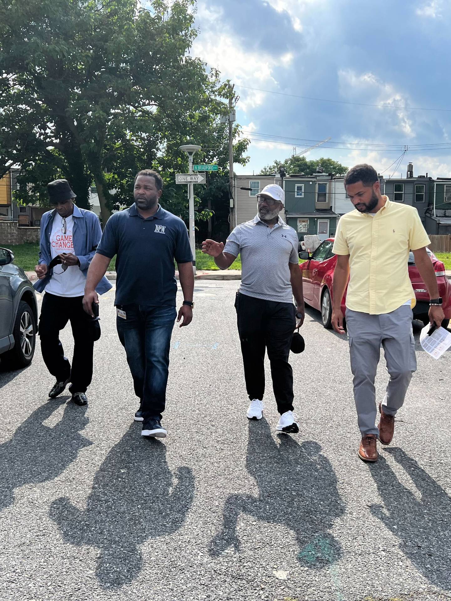 From right to left, Rick Leandry of the Mayor's Office of Neighborhood Engagement and Safety, neighborhood leader Terry "Uncle T" Williams, and Terrance Brown of the Department of Public Works walk the area of North Milton and Milliman Streets, searching for quality of life issues for city workers to address.