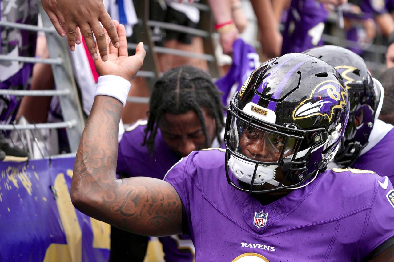 Ravens quarterback Lamar Jackson slaps hands with fans at M&T Bank Stadium before the Ravens face the Texans in the season opener against the Houston Texans.