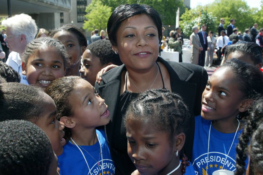 Retired gymnast Dominique Dawes is surrounded by fans at a Physical Activity Day event on May 1, 2002, in Washington.