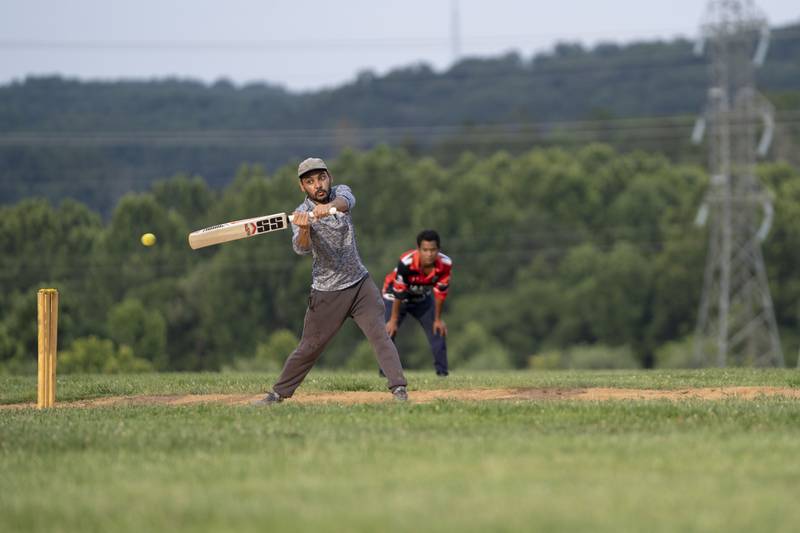 A cricket player takes his turn at the bat during practice July 27. Players switch positions so most members can train in different roles.