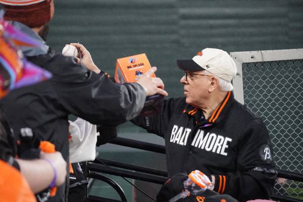 Orioles control person David Rubenstein signs autographs for fans while serving as "Mr. Splash" during a game between the Arizona Diamondbacks and Baltimore Orioles on Friday, May 10.