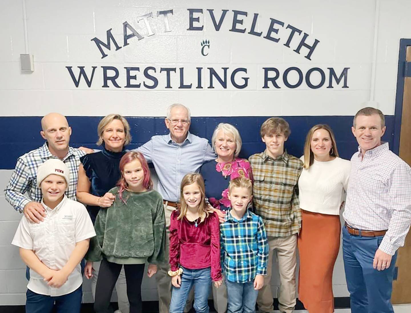 The family of Matt Eveleth at the dedication of the Matt Eveleth Wrestling Room at Chesapeake-AA High School. (Back row from left) Matt's eldest brother, Brian Jr., wife, Amy, father, Brian Sr., mother, Naomi, nephew, Toby, sister-in-law, Asahi, brother, Jeff. (Front row from left) Matt Eveleth's nieces and nephews Drew, Natalie, Molly and Charlie.