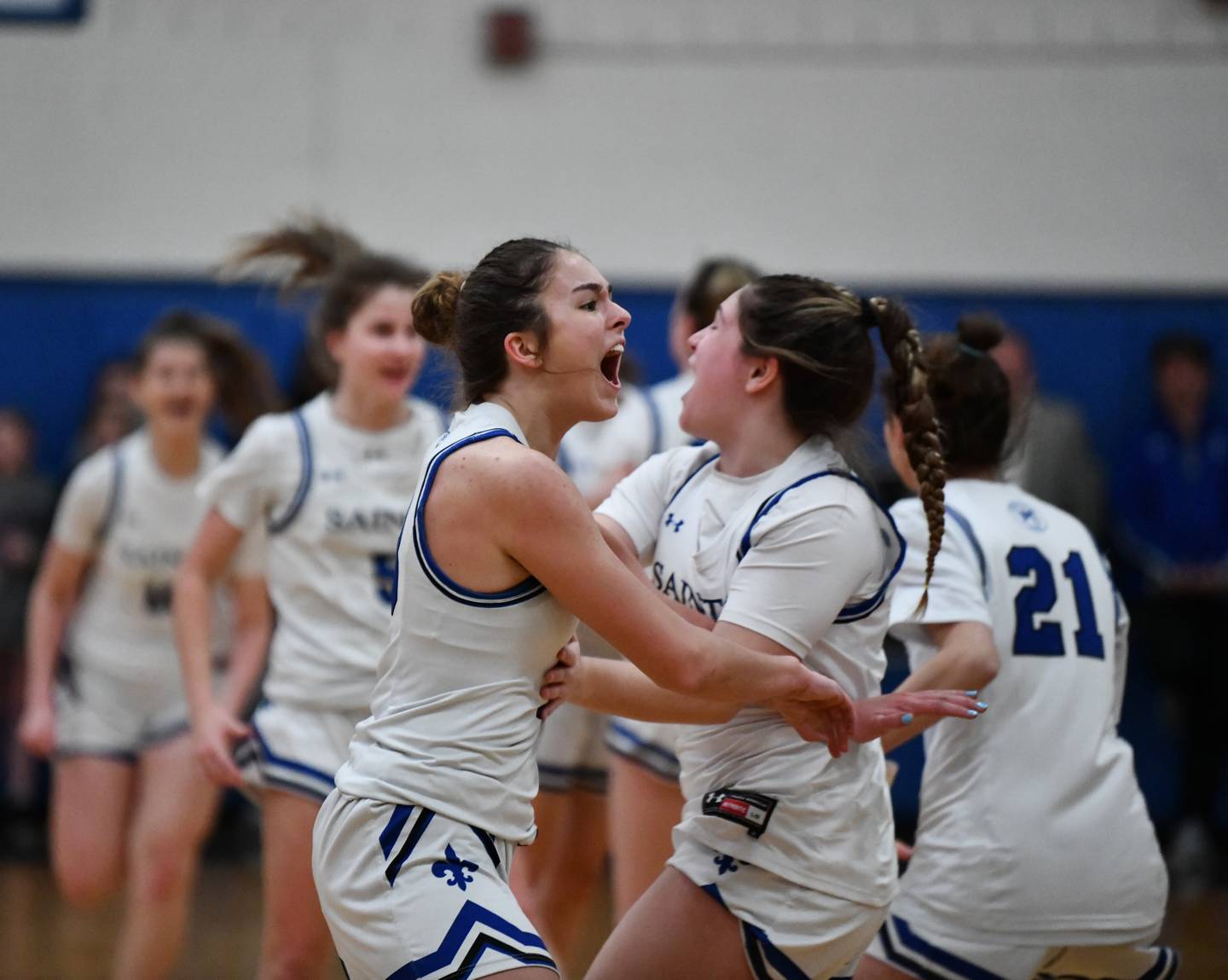 Bailey Harris (left) exults in jubilation with Baily Walden after St. Mary's girls basketball team's victory over Concordia Prep Thursday evening. The undefeated and No. 8 Saints advanced to the IAAM B Conference championship game with a come-from-behind semifinal victory in Annapolis.