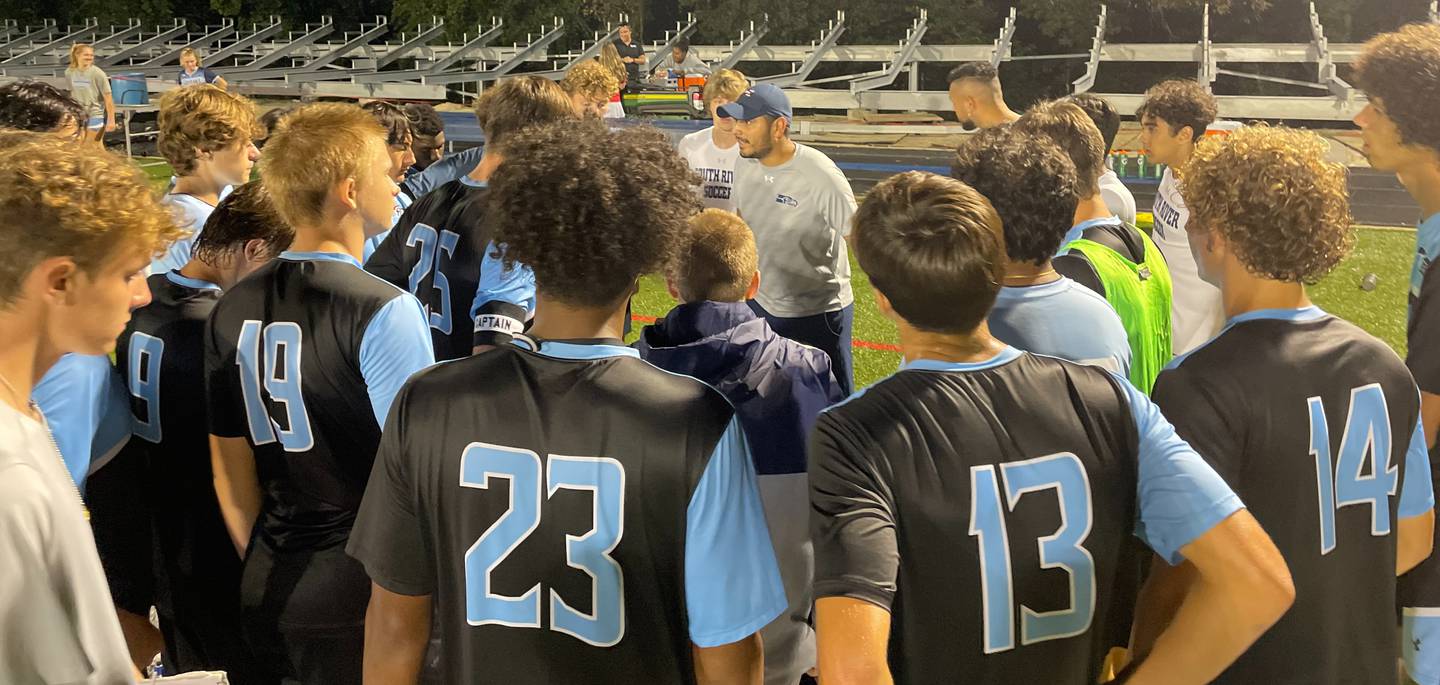 South River boys soccer coach Marlyn Argueta (center with hat) talks to his team during Monday evening's non-league contest with Bel Air. After 100 minutes of play, the Seahawks finished in a scoreless tie with the Bobcats in Anne Arundel County.