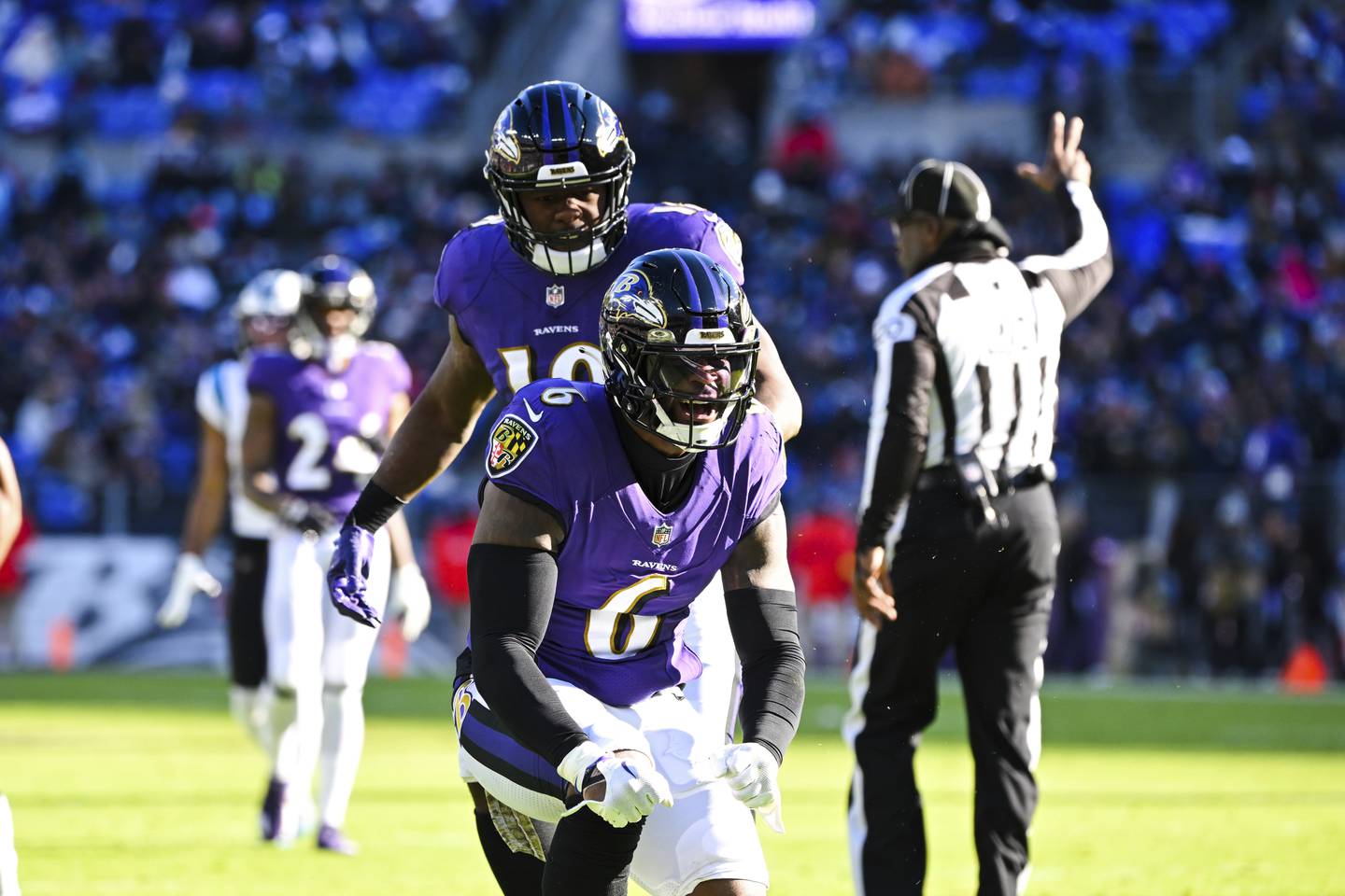 Baltimore Ravens linebacker Patrick Queen (6) celebrates a tackle with linebacker Roquan Smith during the first half of an NFL football game against the Carolina Panthers, Sunday, Nov. 20, 2022, in Baltimore.