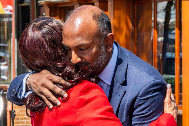 Mayoral candidates Thiru Vignarajah and Sheila Dixon hug Wednesday as Vignarajah ended his campaign and endorsed Dixon.