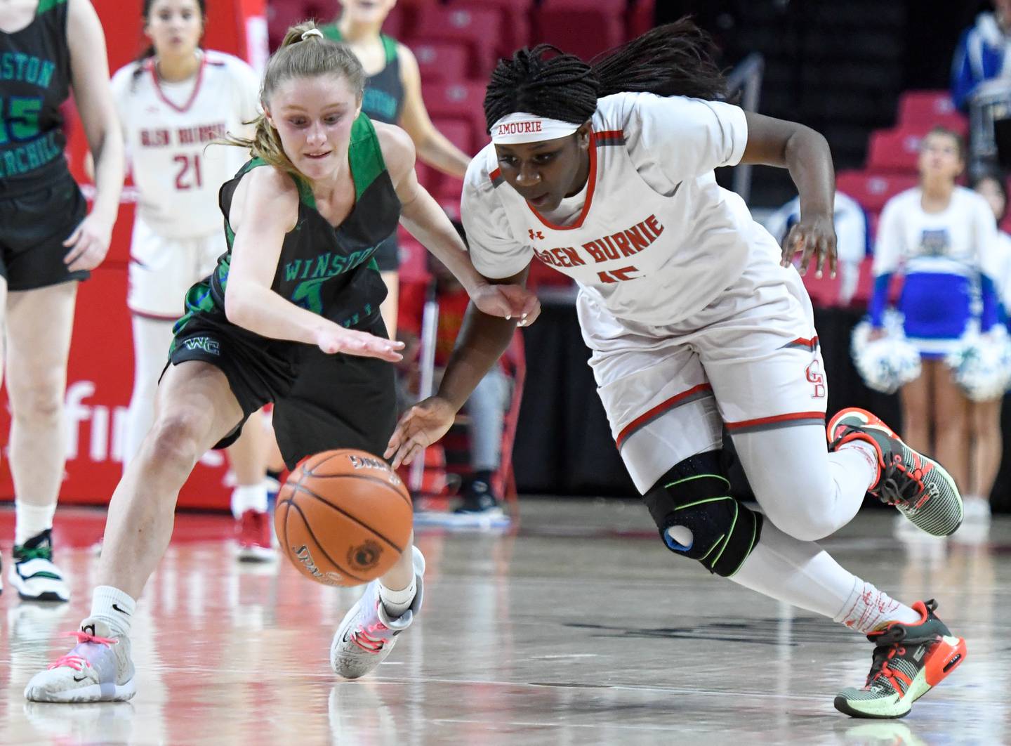 Glen Burnie's Amourie Porter, right, and Churchill's Chelsea Calkins vie for a loose ball during the Class 4A state girls basketball final in College Park on Friday, March 10, 2023.