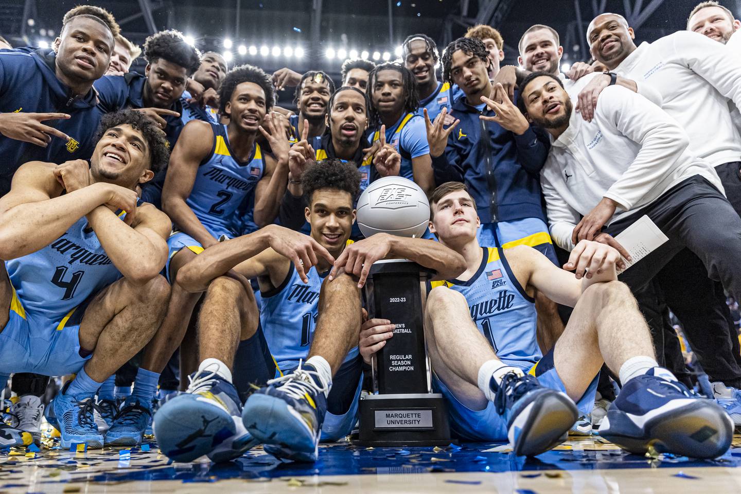 Marquette's players and coaches pose with the Big East Championship trophy