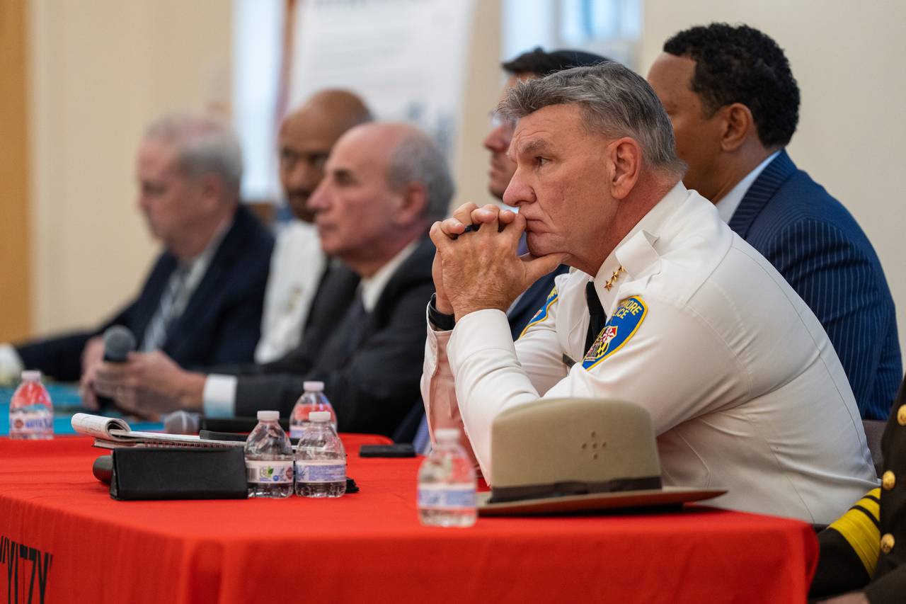 Baltimore Police Commissioner Richard Worley rests his chin on his hands.