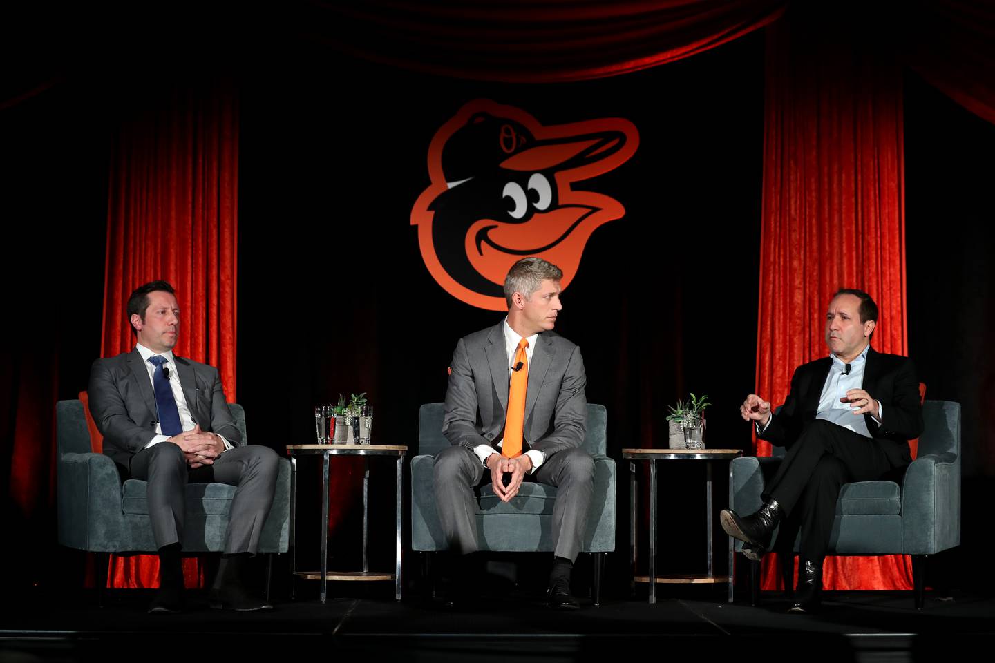 BALTIMORE, MD - NOVEMBER 19: Louis Angelos (L) and John Angelos (R) of the Baltimore Orioles look on after introducing Mike Elias (C) to the media as the Orioles Executive Vice President and General Manager during a news conference at Oriole Park at Camden Yards on November 19, 2018 in Baltimore, Maryland.