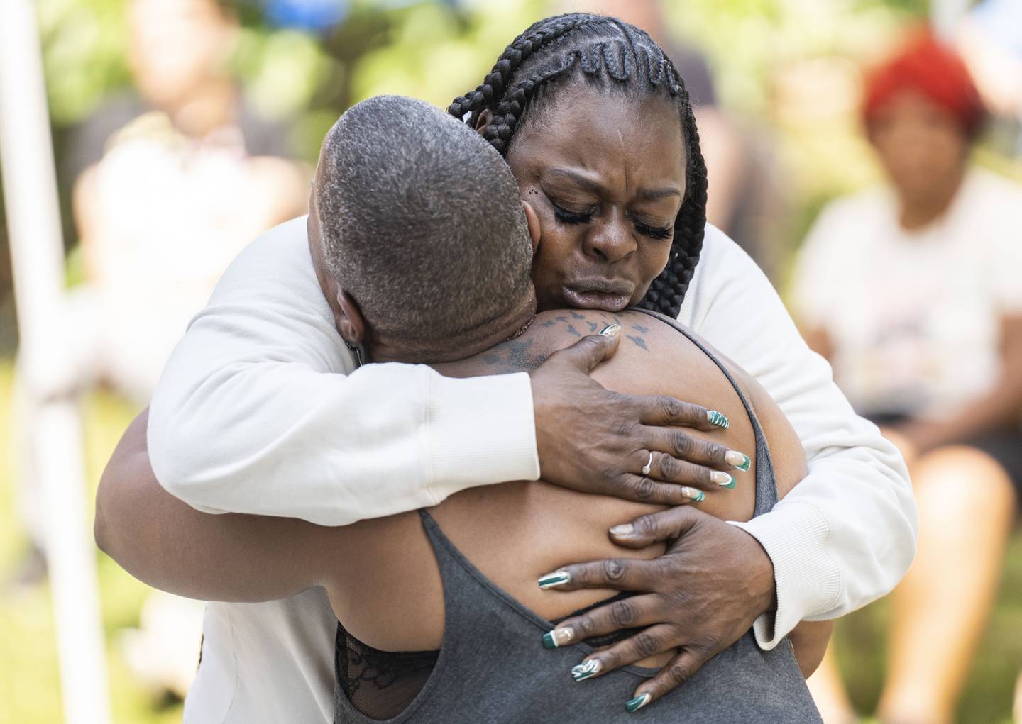 Sonya Williams hugs Baltimore activist Erricka Bridgeford at North Avenue Mission’s third-anniversary celebration in May.