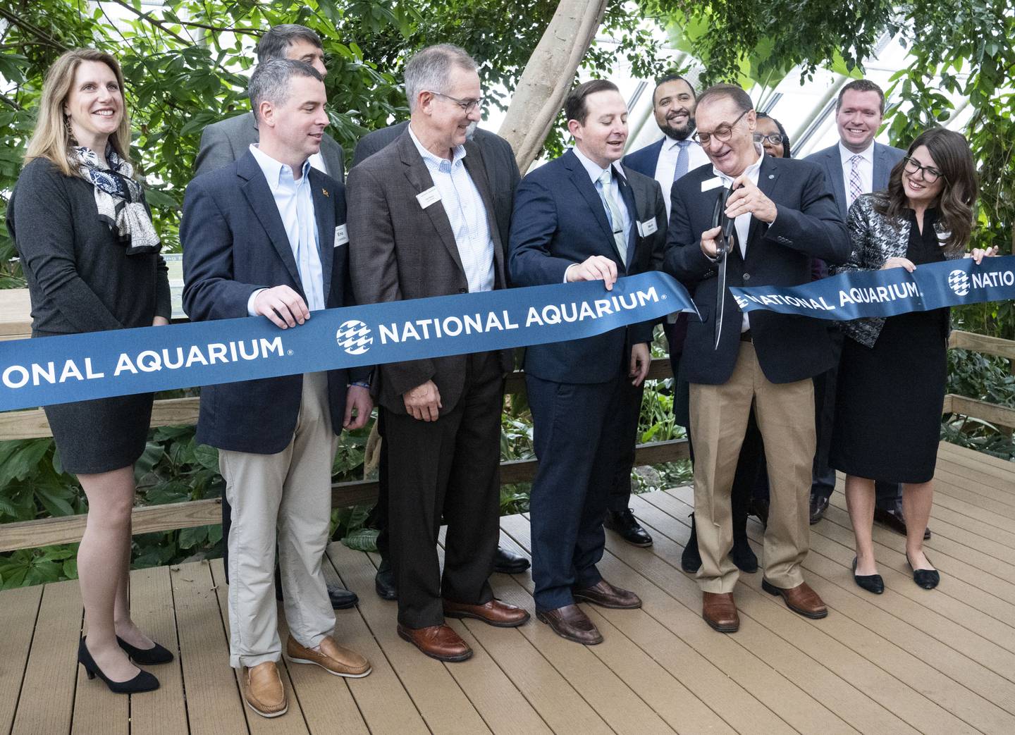 John Racanelli, president and CEO of the National Aquarium, cuts the ribbon during the Rainforest exhibit reopening, in Baltimore, Tuesday, November 15, 2022.