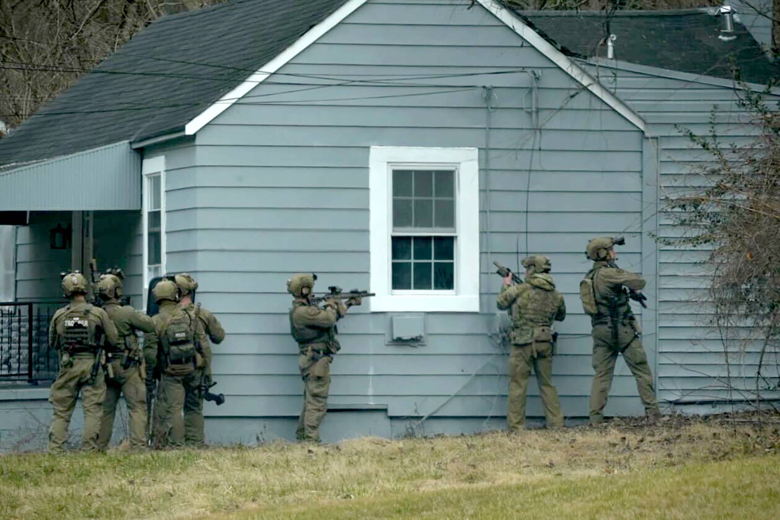 A SWAT team investigates a house on Warren Rd near Loch Raven Reservoir during a manhunt for 24-year-old Cockeysville resident David Emory Linthicum.