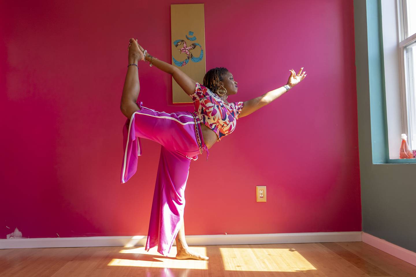 Nazaahah Amin practices the dancer pose in Ama Wellness Yoga.