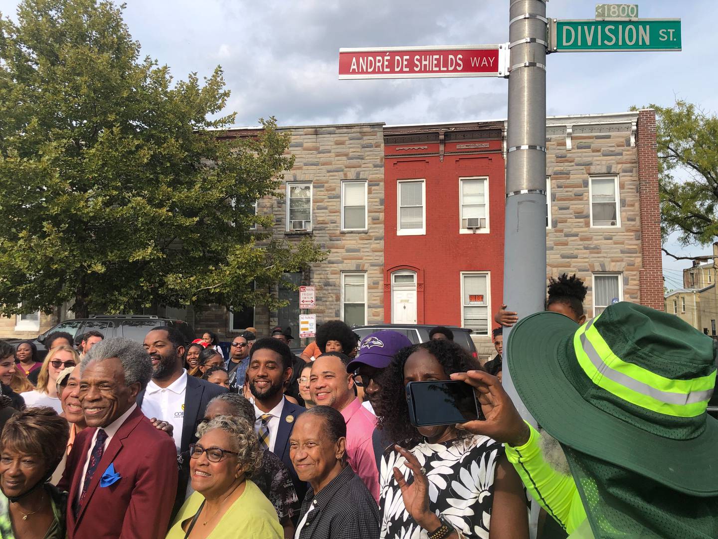 Andre De Shields, dressed in a slim cut crimson suit, was in Baltimore Thursday as the 1800 block of Division Street in the Upton neighborhood where he grew up, was renamed in his honor.
