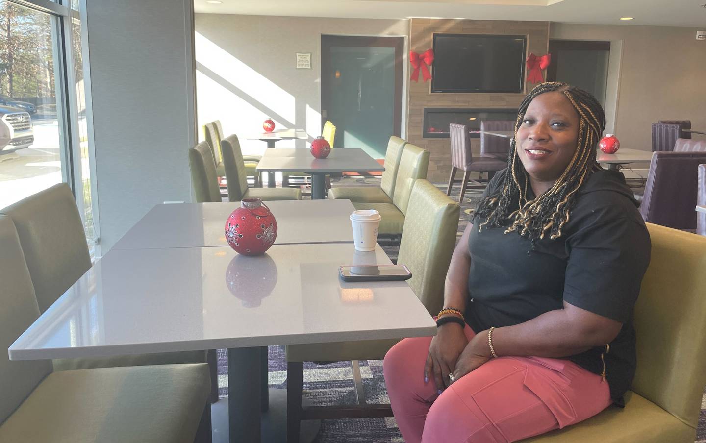 Lisa Grove sits in the dining area of the La Quinta Inn & Suites in Linthicum Heights. She was due to vacation in Puerto Rico with her husband before cancellations left the couple stuck outside BWI.
