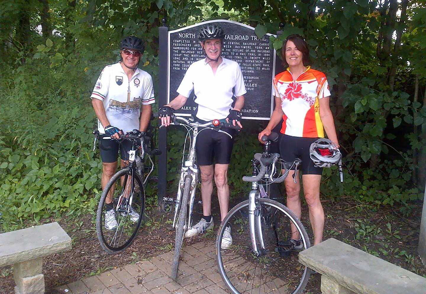 2014 photo of Brian Frosh, center, is pictured with Vincent DeMarco, left, and DeMarco’s wife, Molly Mitchell, during a bike ride on the Northern Central Railroad Trail.