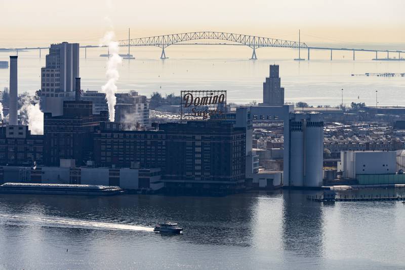 The Domino Sugar Factory, with the Francis Scott Key Bridge in the background, is seen on Thursday, March 14, 2024.