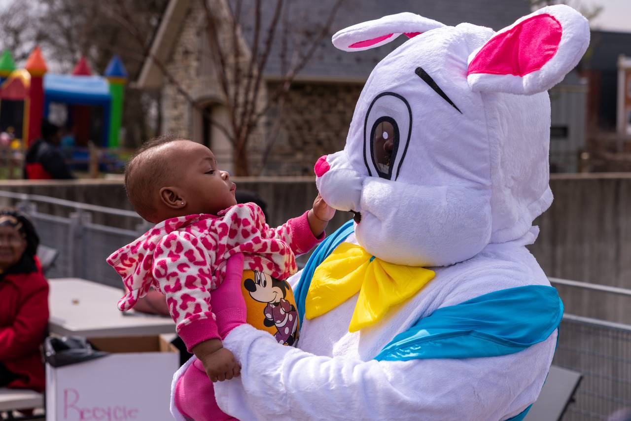 Anyla Coles, 7 months, with the easter bunny, tries to grab the Easter Bunny's nose at the . Parks & People Easter Egg Hunt, Mar 30 2024, Baltimore, MD.