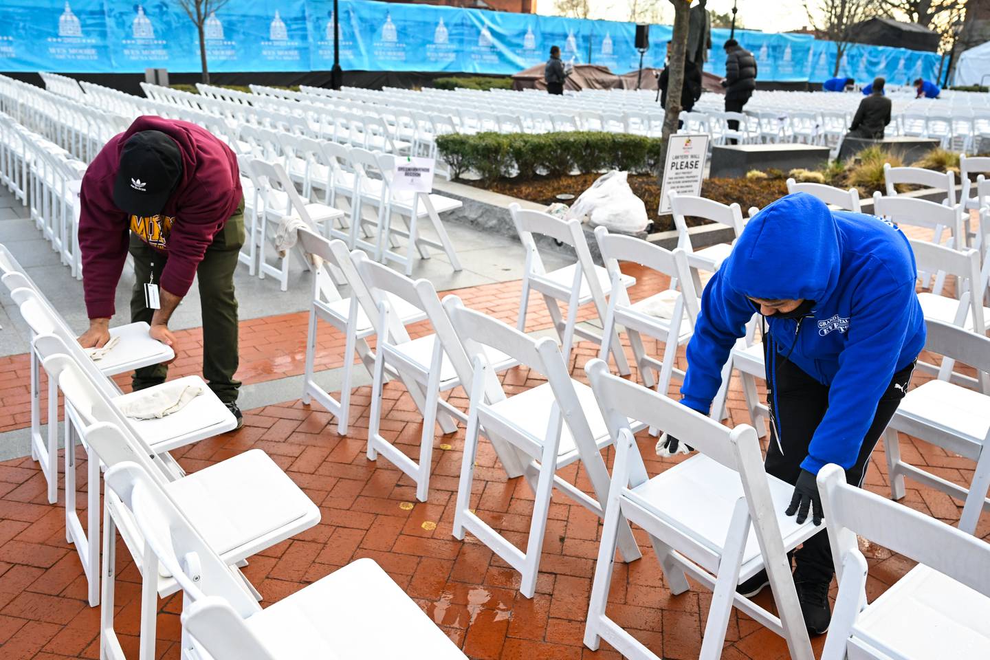 Workers clean water from chairs before the swearing in ceremony of Wes Moore, Wednesday, Jan. 18, 2023, in Annapolis.