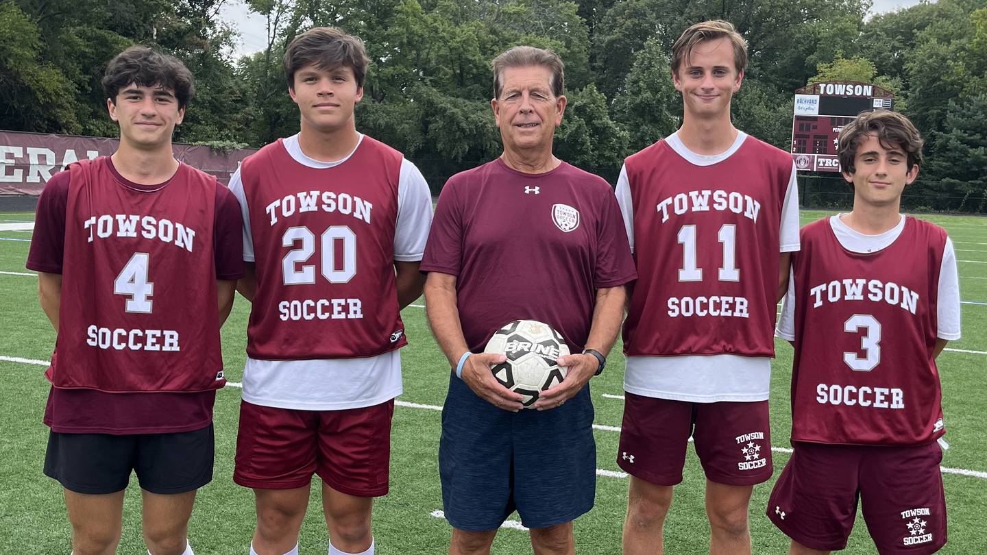 (From left) Towson High soccer captains - junior Jake DelViscio and seniors Parker Fong, Jensen Specht and Vinny Guida - flank Towson coach Randy Dase, center, at practice the day before the Generals host arch-rival Dulaney on Tuesday in the Men’s Cancer Awareness game. Dase is a cancer survivor who was treated at the Brady Urological Institute at Johns Hopkins Hospital.