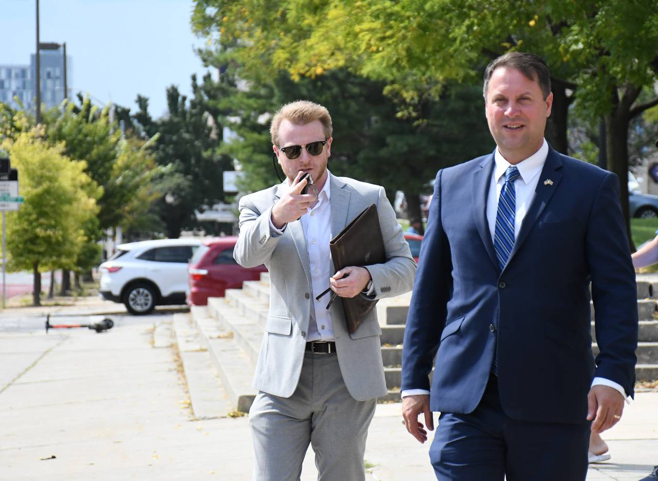 Maryland Republican gubernatorial candidate Dan Cox, right, and campaign manager Zach Werrell arrive at Baltimore City's school headquarters building on Monday, Sept. 19, 2022 for a press conference they called to criticize opponent Wes Moore's book, "The Other Wes Moore."