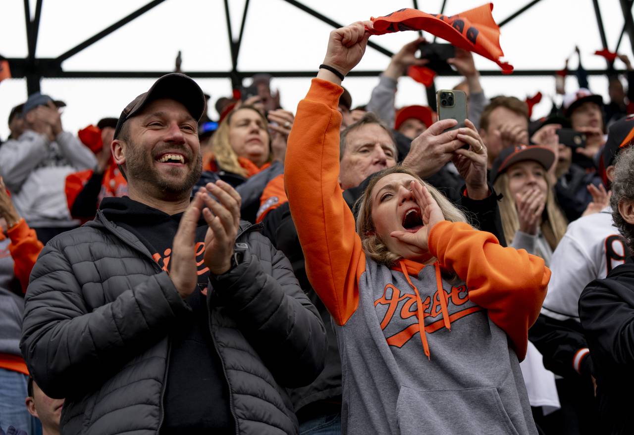 Amaris Puzak, right, and Andrew Mannion, left, rally for the Orioles on Opening Day at Camden Yards on March 28, 2024.