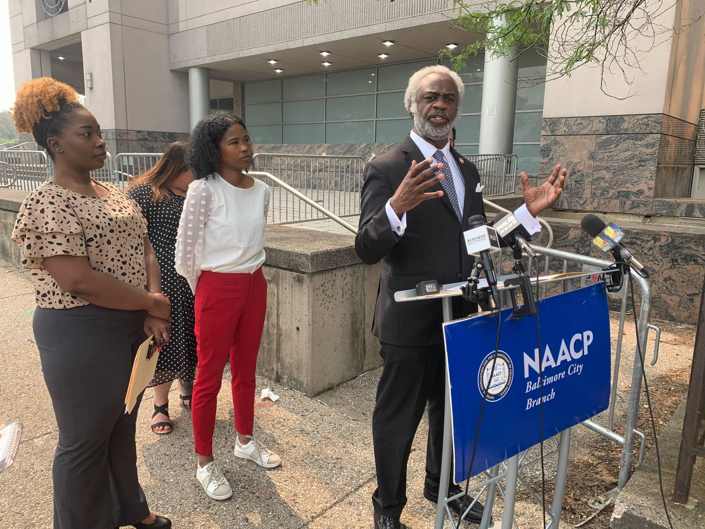 Rev. Kobi Little of Baltimore's NAACP chapter speaks outside BPD headquarters on Thursday. He decried what he called a lack of transparency from Mayor Brandon Scott in the selection of Acting Police Commissioner Richard Worley.