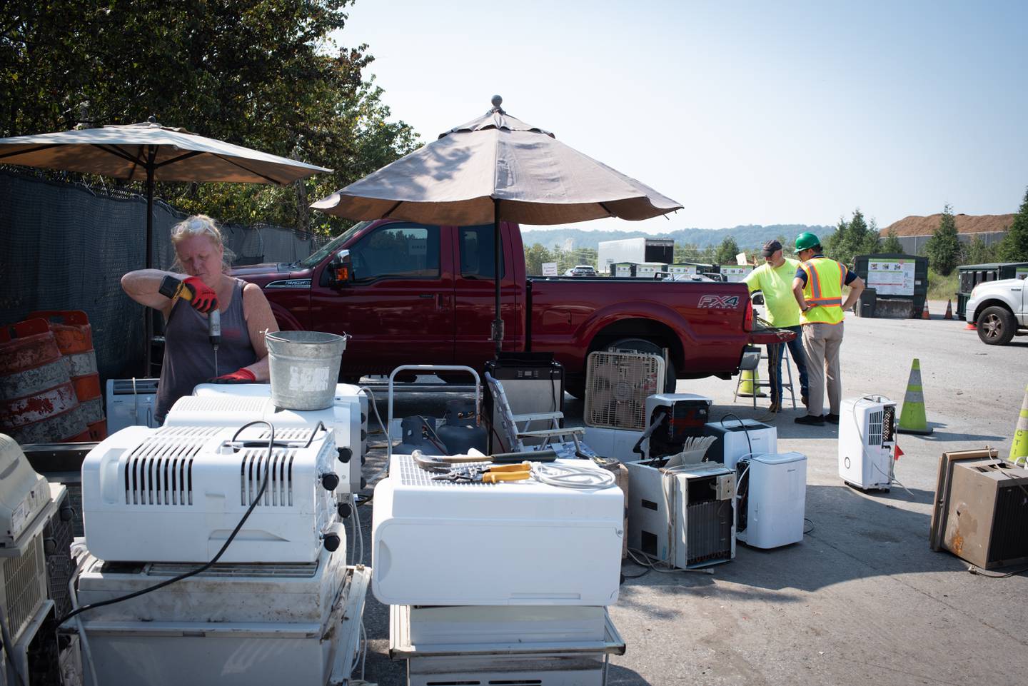 A staff member taking apart cooling equipment. September 7, 2023.