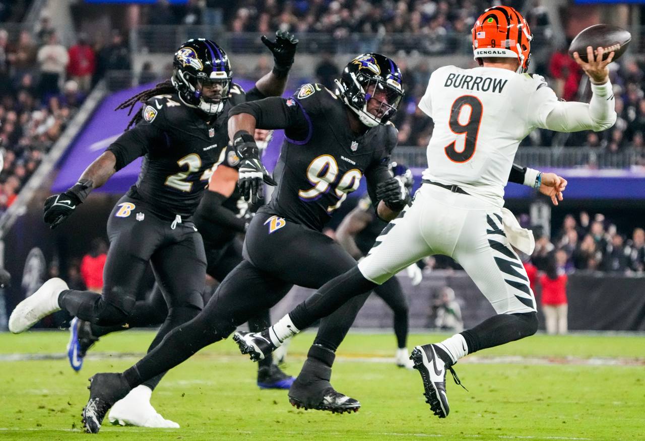Baltimore Ravens linebacker Odafe Oweh (99) pressures Cincinnati Bengals quarterback Joe Burrow (9) during the second quarter at M&T Bank Stadium on Thursday, Nov. 16, 2023.