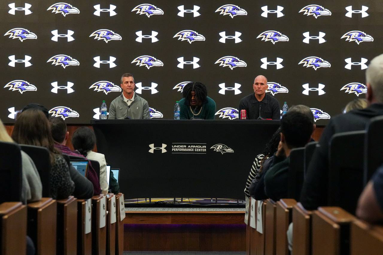 From left: Baltimore Ravens Head Coach John Harbaugh, quarterback Lamar Jackson and General Manager Eric DeCosta answer questions during a press conference at the Under Armour Performance Center on Thursday, May 4. Jackson and the Ravens recently came to an agreement on his contract extension, a 5-year deal worth $260 million.