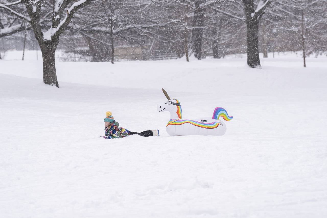 Sloane Morris, 7, has fun in the snow on her unicorn float on January 19, 2024 after Baltimore received several inches of snow. This was her first memorable experience playing in the snow, to which she declared, "It's awesome!"