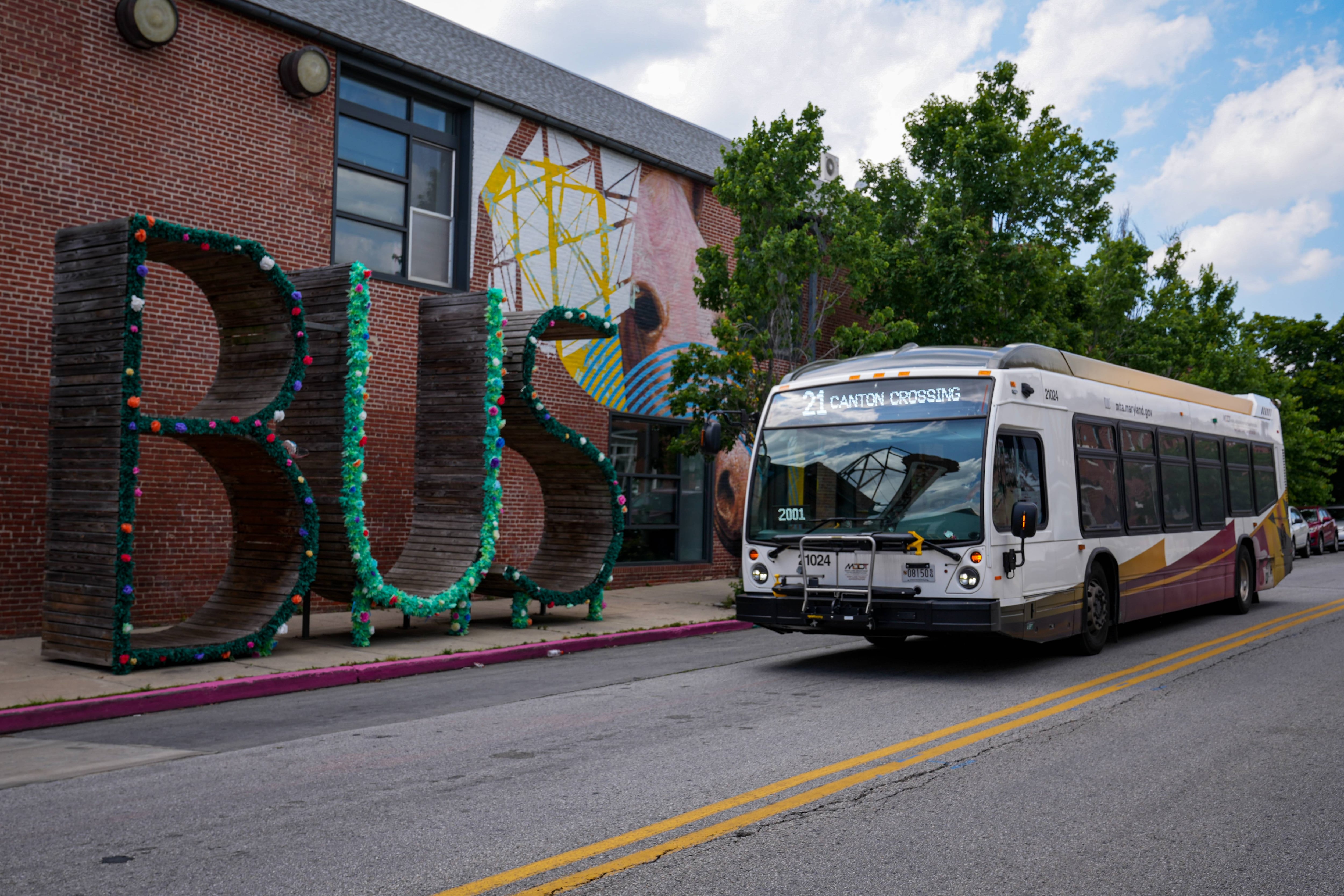 6/8/22—A Baltimore City Bus drives past the BUS shaped bus stop outside of the Creative Alliance art center in Highlandtown.