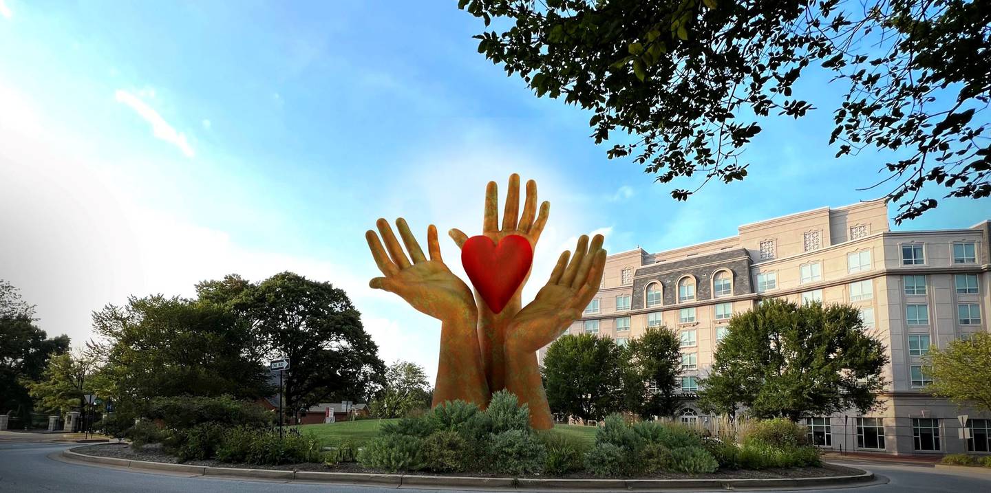 One proposal features three hands in the center of the circle, holding a red hart. The proposal from Washington, D.C. artist  Jay Coleman was submitted by an anonymous Annapolis family that offered funding.