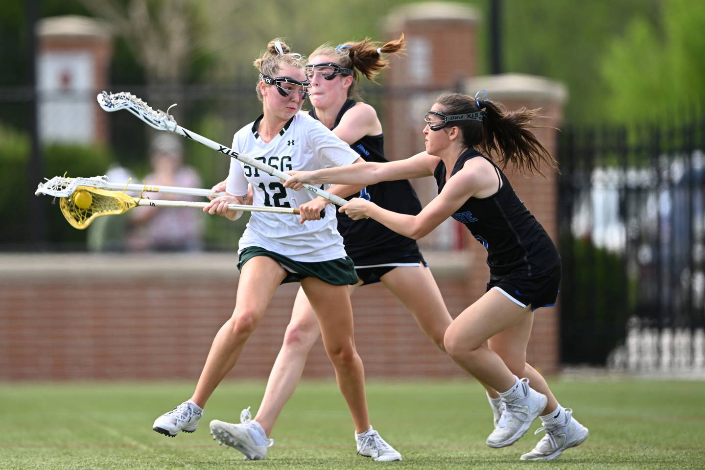 St. PaulsÕ Marleigh OÕDay (12) prepares to shoot as DarienÕs Maggie Bellisimo (5) and Morgan Massey (7) defend in the first half of a lacrosse game Saturday, April 15, 2023, in Sparks Glencoe, MD.