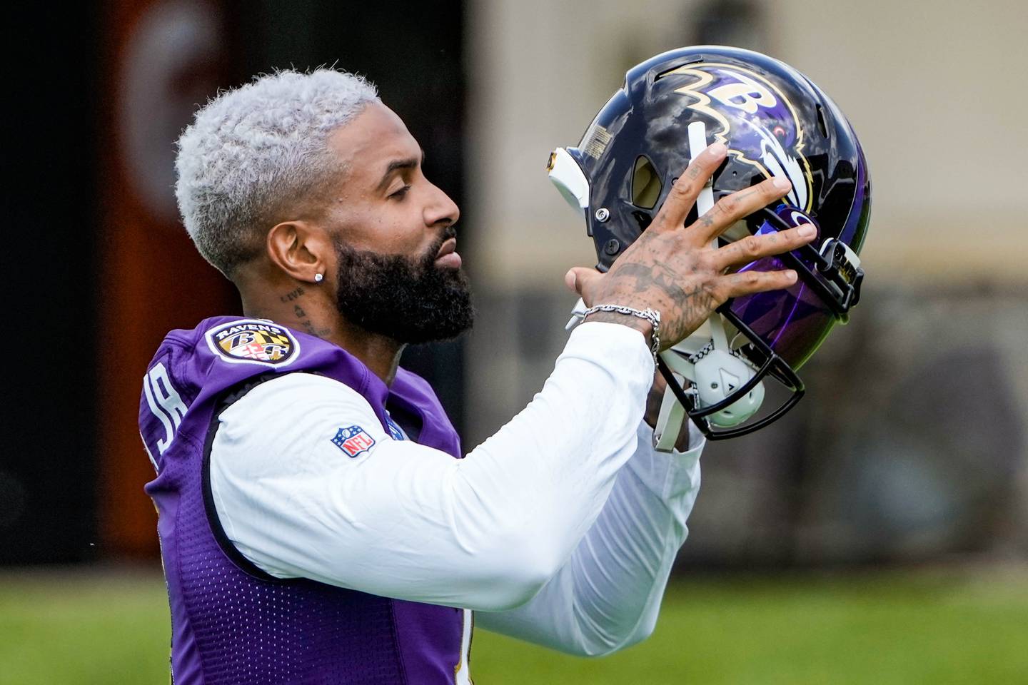 Ravens WR Odell Beckham Jr. puts on his helmet at the first Ravens practice of the season on July 26, 2023.