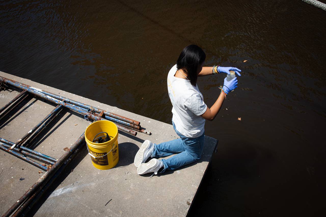 Makayla Stewart, an intern at the Institute of Marine and Environmental Technology (IMET), sampling the water for a potential mahogany tide in the Inner Harbor.