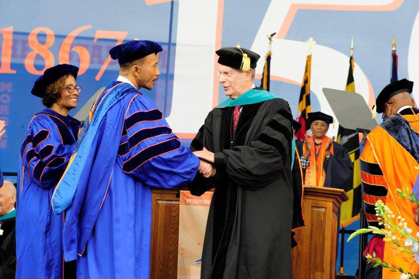 Sheldon Goldseker shakes hands with Congressman Kweisi Mfume at Morgan State University's commencement ceremony in 2017.