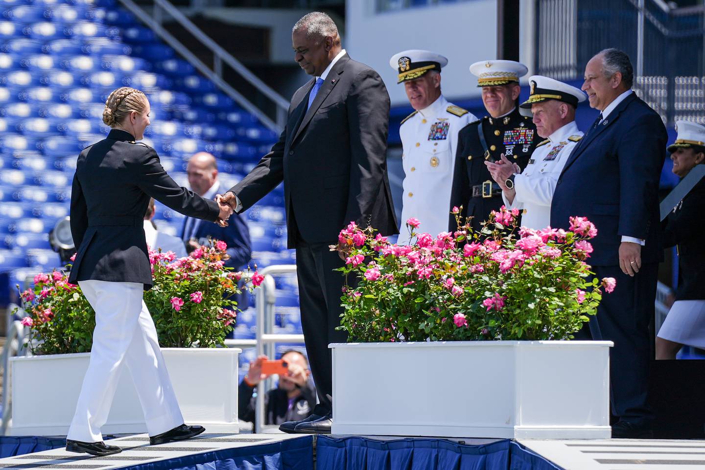 Megan Sara Welch, the last student on the list in 30th Company, approaches the stage to receive her diploma and shake hands with U.S. Secretary of Defense Lloyd James Austin III during the U.S. Naval Academy’s graduation ceremony at the Navy-Marine Corps Memorial Stadium on May 26, 2023. The graduating midshipmen are commissioned as either an ensign in the U.S. Navy or a 2nd Lieutenant in the U.S. Marine Corps.