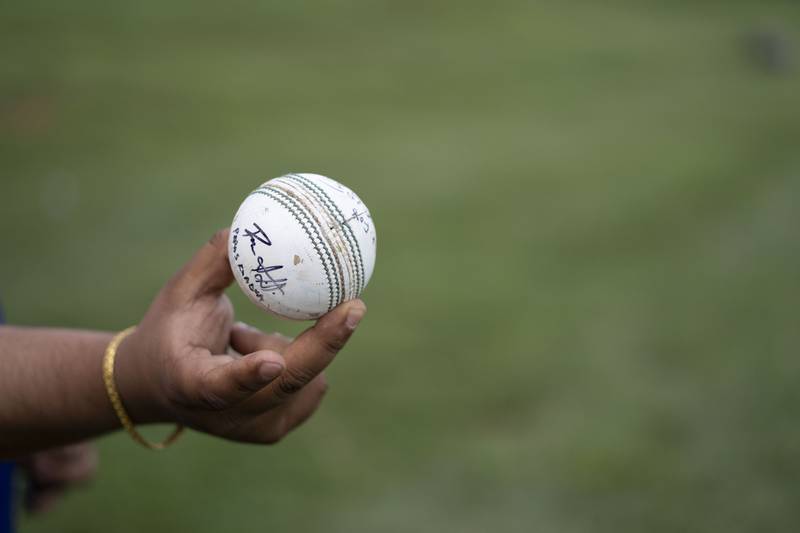 Utsav Sigdel, cricket director for Saathi Baltimore Cricket Club, shows off a signed ball. Sigdel got this ball at a professional match after it was hit out of bounds.