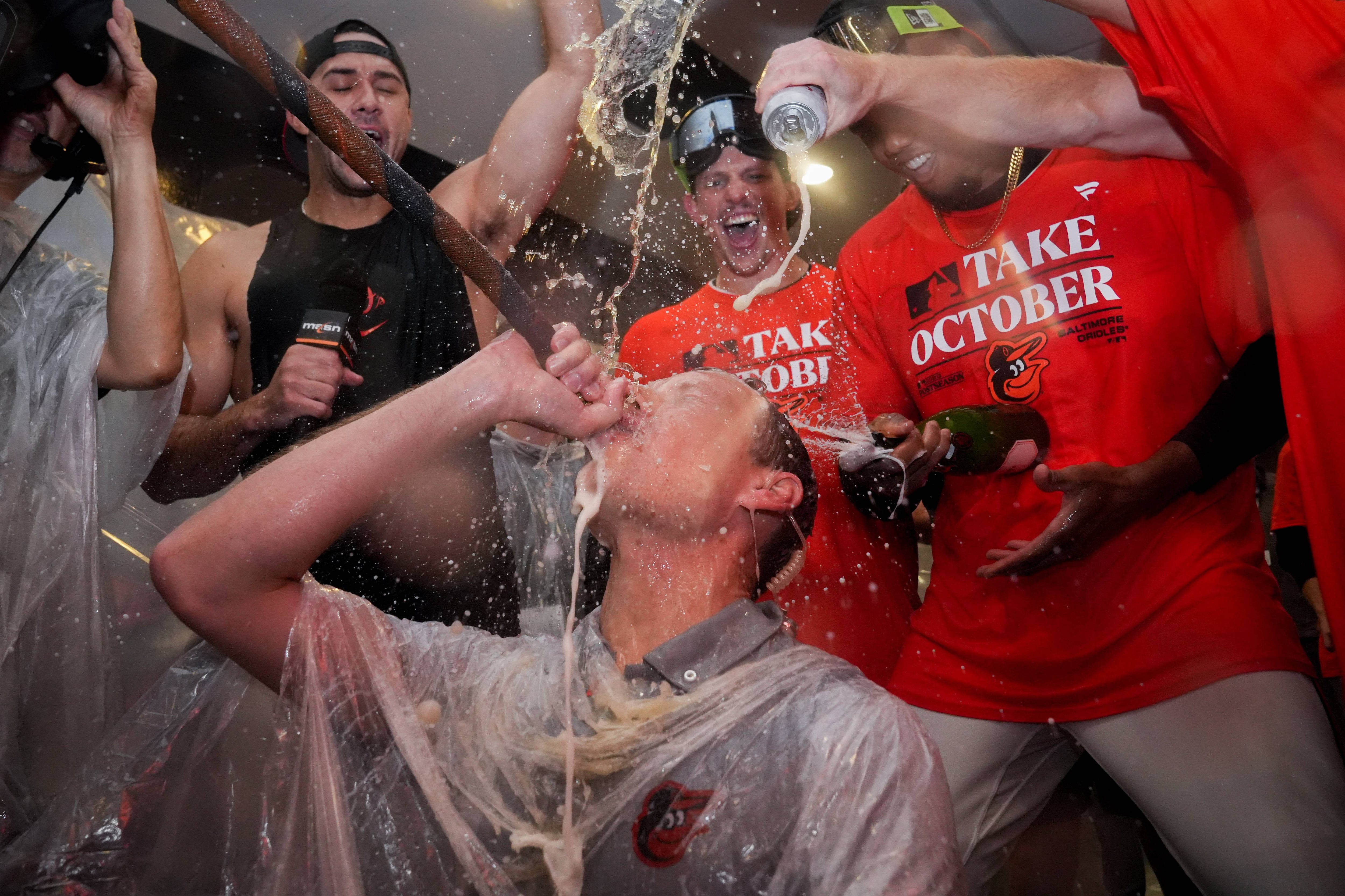 ESPN and Baltimore Orioles broadcaster Kevin Brown is doused with beer and champagne in the clubhouse following the team’s playoff-clinching win against the Tampa Bay Rays on Sunday, September 17, 2023. The Orioles earned a spot in the playoffs for the first time since 2016.