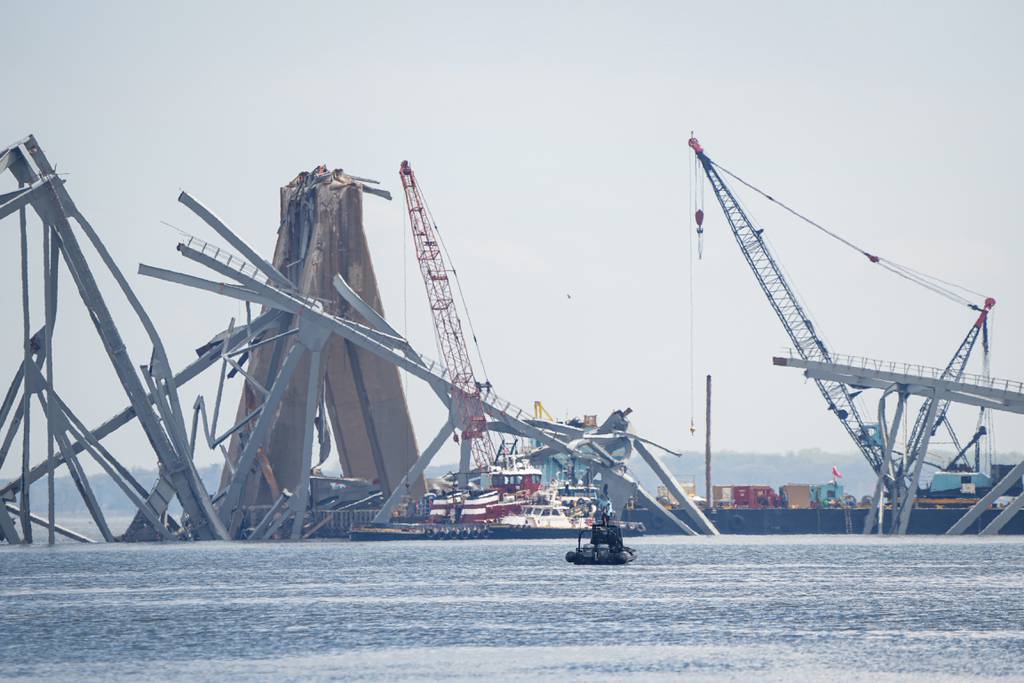 Remnants of the collapsed Francis Scott Key Bridge are lifted up by cranes, seen from a Department of Natural Resources boat on the Patapsco River in Baltimore, on April 10, 2024.