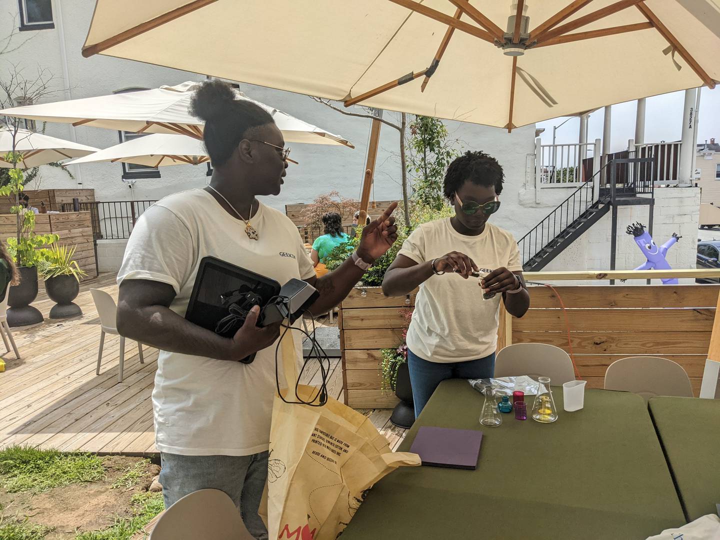 Nnadagi and Louise Isla are setting up their science themed booth at Good Neighbor to launch their coffee brand "Before Tush."
