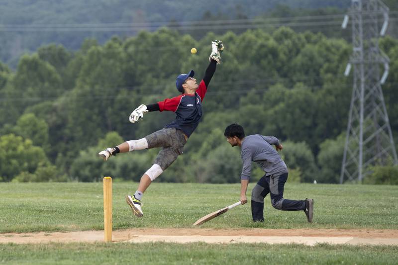 Samyog Parajuli attempts to catch the ball during cricket practice July 27.