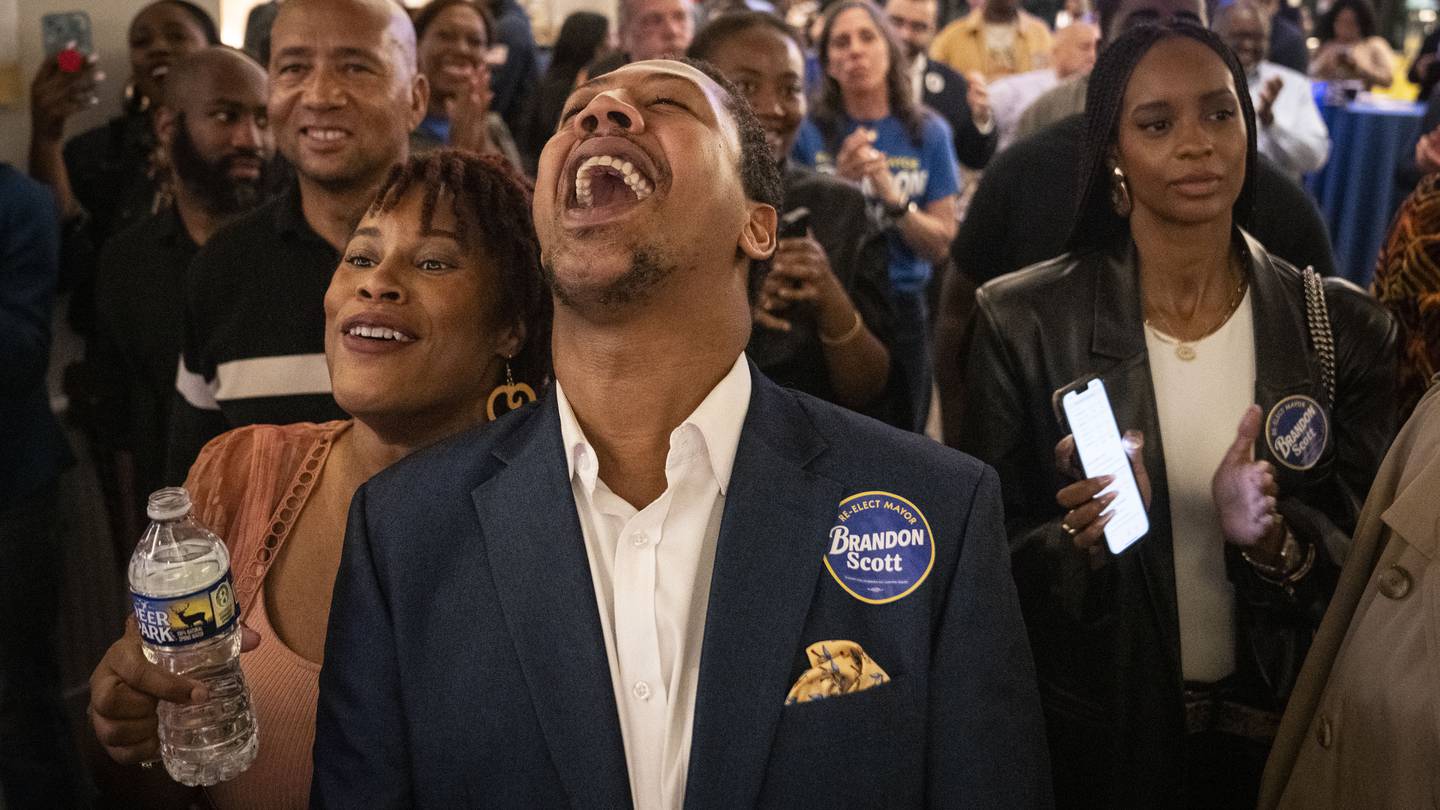 Tierra Taylor and James Lynch cheer as Baltimore Mayor Brandon Scott comes to the stage at Mayor Scott's election night event and watch party.