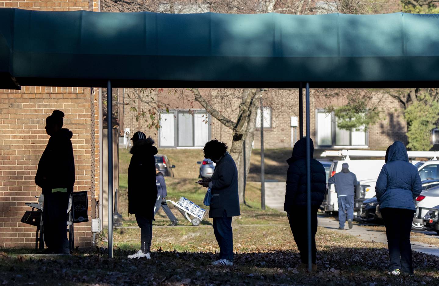Residents of the five Glen Burnie apartment communities that makeup the Hendersen Webb, Inc.-owned The Forest wait to pay rent in lieu of eviction as sheriff's deputies prepare to begin evictions in Glen Burnie, Tuesday, November 22, 2022.
