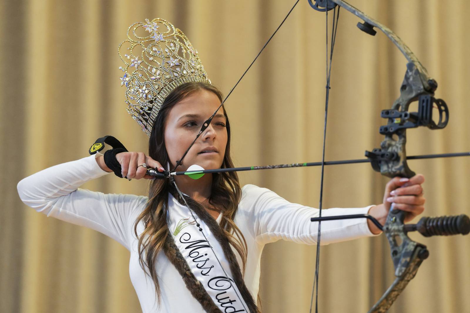 Miss Outdoors 2023, Skye Adshead, 20, shoots a bow and arrow for her talent where she managed to pop all four balloons.