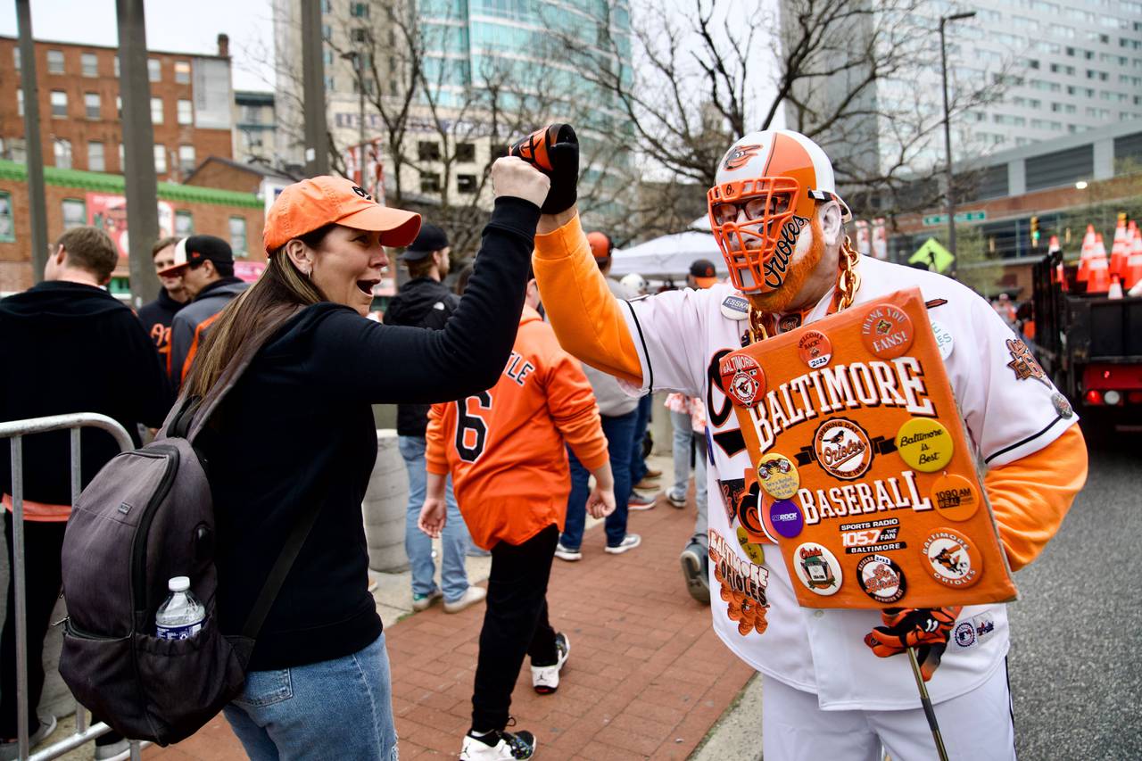 Pat McFaul of Rosedale also know by his nickname “Old School” high-fives fans as they make their way around Camden yards before the Home Opener Orioles against divisional rivals New York Yankees.