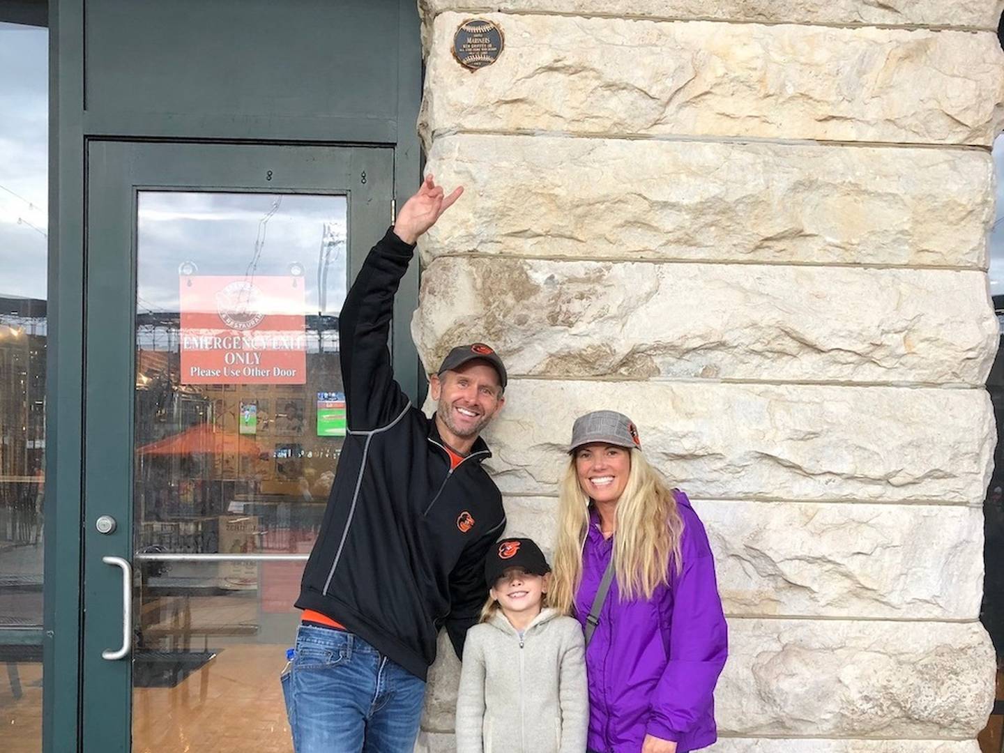 Mark Pallack poses with his daughter and wife near the plaque marking the spot where Ken Griffey Jr.'s Home Run Derby shot hit the Warehouse at Camden Yards in 1993. Pallack snagged the ball after it ricocheted off the wall. (Photo courtesy of Mark Pallack)