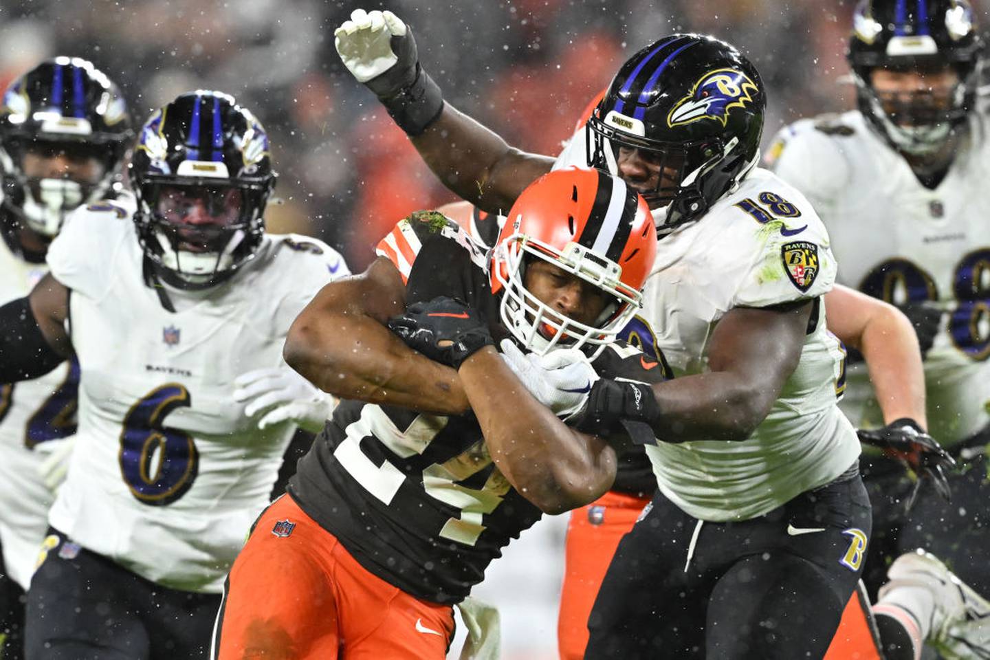 CLEVELAND, OHIO - DECEMBER 17: Nick Chubb #24 of the Cleveland Browns is hit by Roquan Smith #18 of the Baltimore Ravens during the fourth quarter at FirstEnergy Stadium on December 17, 2022 in Cleveland, Ohio.